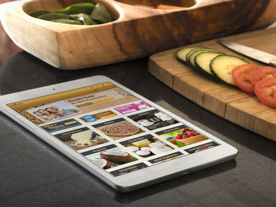 Shopping for food in the kitchen using the Honeyville website on a tablet