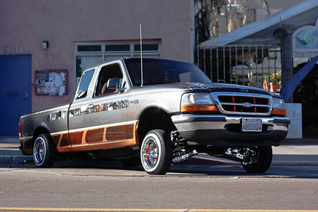 Low ridding Ford Ranger with white walls and custom paint.